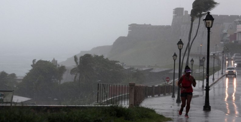 A woman runs in the rain as Hurricane Irma slammed across islands in the northern Caribbean on Wednesday, in San Juan A woman runs in the rain as Hurricane Irma slammed across islands in the northern Caribbean on Wednesday, in San Juan