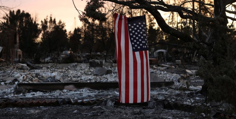 An American flag hangs from a tree in a neighborhood destroyed by wildfire in Santa Rosa, California, U.S. An American flag hangs from a tree in a neighborhood destroyed by wildfire in Santa Rosa, California, U.S.