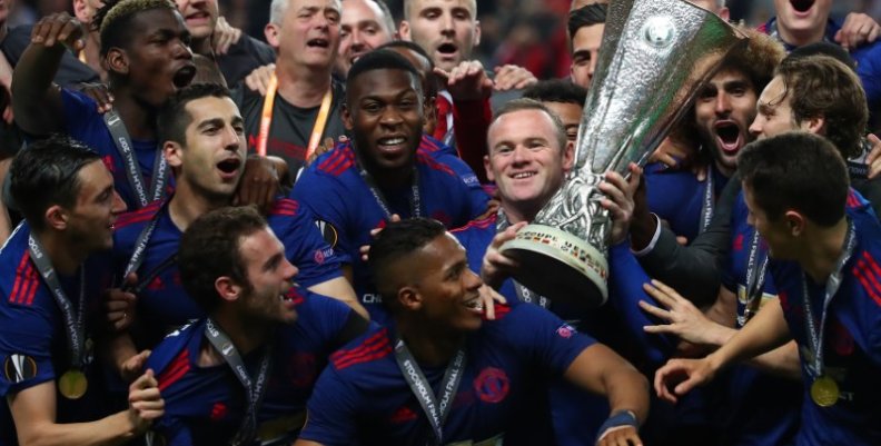 Manchester United's Wayne Rooney and team mates celebrate with the trophy after winning the Europa League Manchester United's Wayne Rooney and team mates celebrate with the trophy after winning the Europa League
