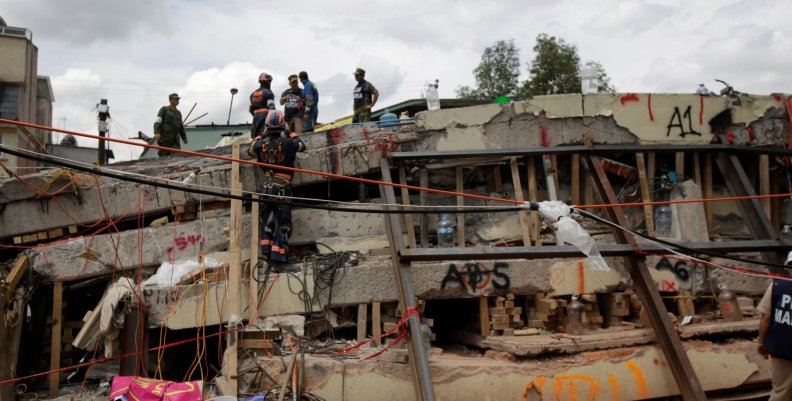 Members of a rescue team search for students amidst the rubble of a collapsed building of the Enrique Rebsamen school after an earthquake in Mexico City Members of a rescue team search for students amidst the rubble of a collapsed building of the Enrique Rebsamen school after an earthquake in Mexico City