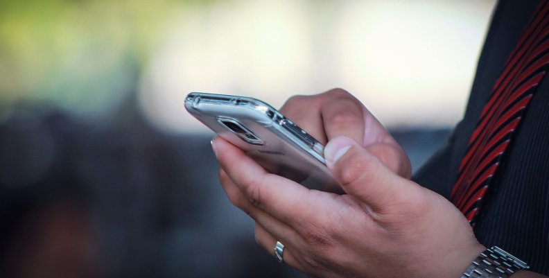 Trabajo Un hombre sosteniendo un celular en su mano
