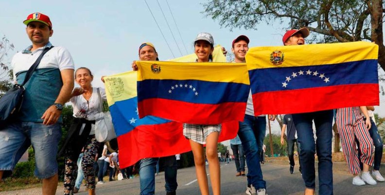 Menores de edad venezolanos Personas caminando con la bandera de Venezuela