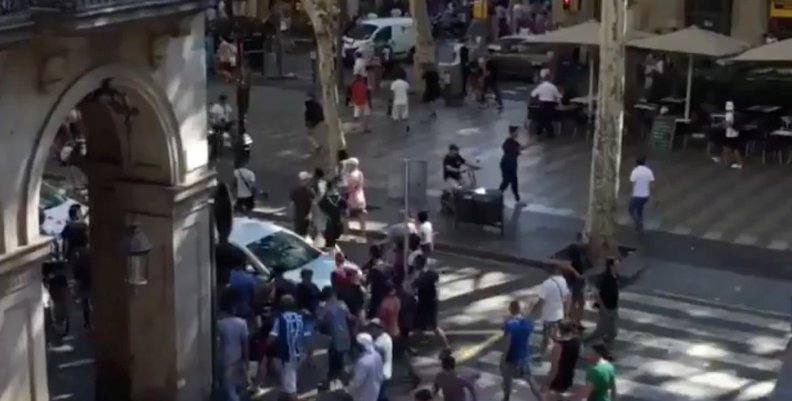 People move from the scene after a van crashed into pedestrians near the Las Ramblas avenue in central Barcelona People move from the scene after a van crashed into pedestrians near the Las Ramblas avenue in central Barcelona