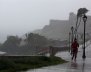 A woman runs in the rain as Hurricane Irma slammed across islands in the northern Caribbean on Wednesday, in San Juan