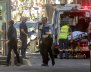 Australian police and paramedics are seen near the place where they arrested the driver of a vehicle that had ploughed into pedestrians at a crowded intersection near the Flinders Street train station, in central Melbourne