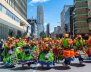 Personas usando trajes típicos de colores bailando en la calle 