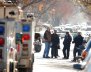 Police gather outside a house in the Brooklyn borough, while they investigate an earlier incident of the reported explosion at the New York Port Authority Bus Terminal in Manhattan, in New York City