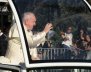 Pope Francis waves while driving through Santiago