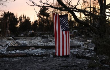 An American flag hangs from a tree in a neighborhood destroyed by wildfire in Santa Rosa, California, U.S.