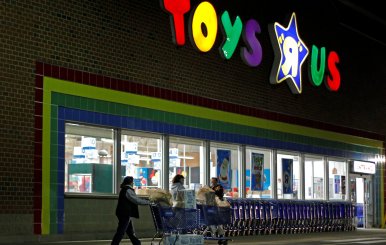 FILE PHOTO:   Consumers leave a Toys R Us store with full shopping carts after shopping on the day dubbed "Black Friday" in Framingham