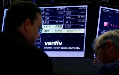 FILE PHOTO:Traders wait for news at the post where U.S. credit card technology firm Vantiv Inc is traded on the floor of the NYSE in New York