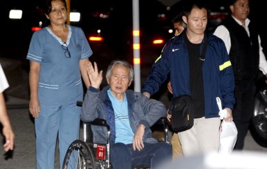 Former Peruvian President Alberto Fujimori accompanied by his son Kenji Fujimori leaves the Centenary hospital in Lima