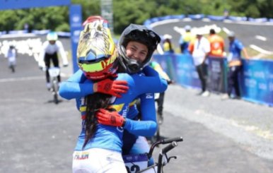 Dos deportistas de uniforme azul abrazadas