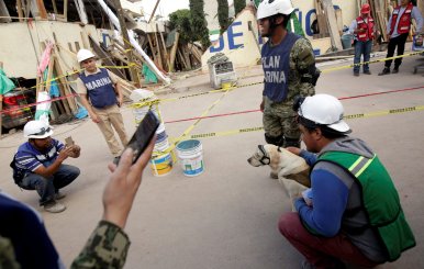 People pose for a picture with rescue dog Frida after an earthquake hit Mexico City, Mexico