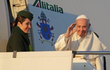 Pope Francis waves as he boards for his trip to Chile and Peru at Fiumicino International Airport in Rome