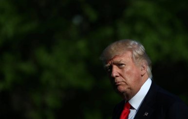 U.S. President Donald Trump walks from Marine One as he returns from a day trip to Atlanta on the South Lawn of the White House in Washington, U.S.